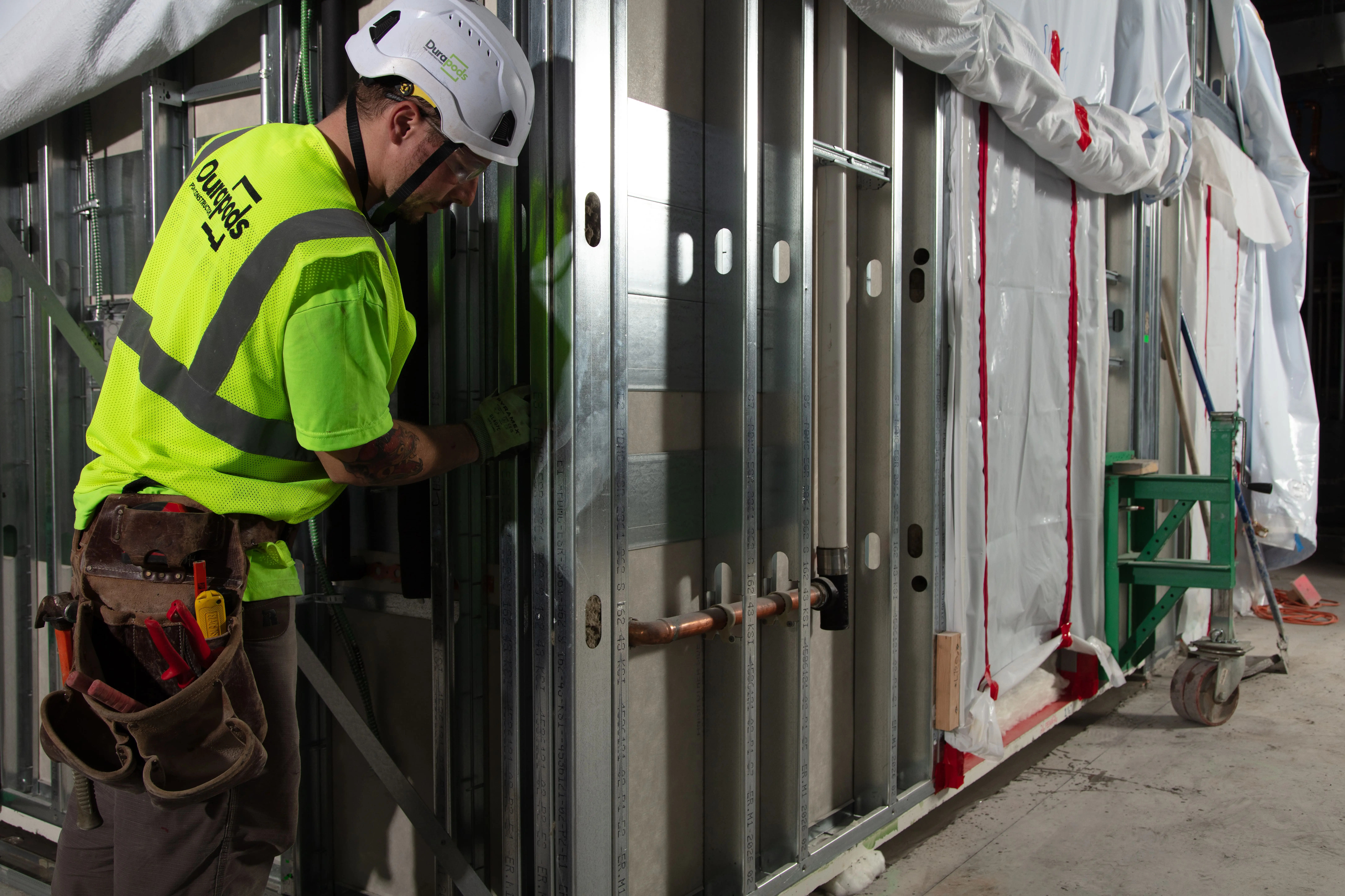 Prefabrication planning session with architectural drawings