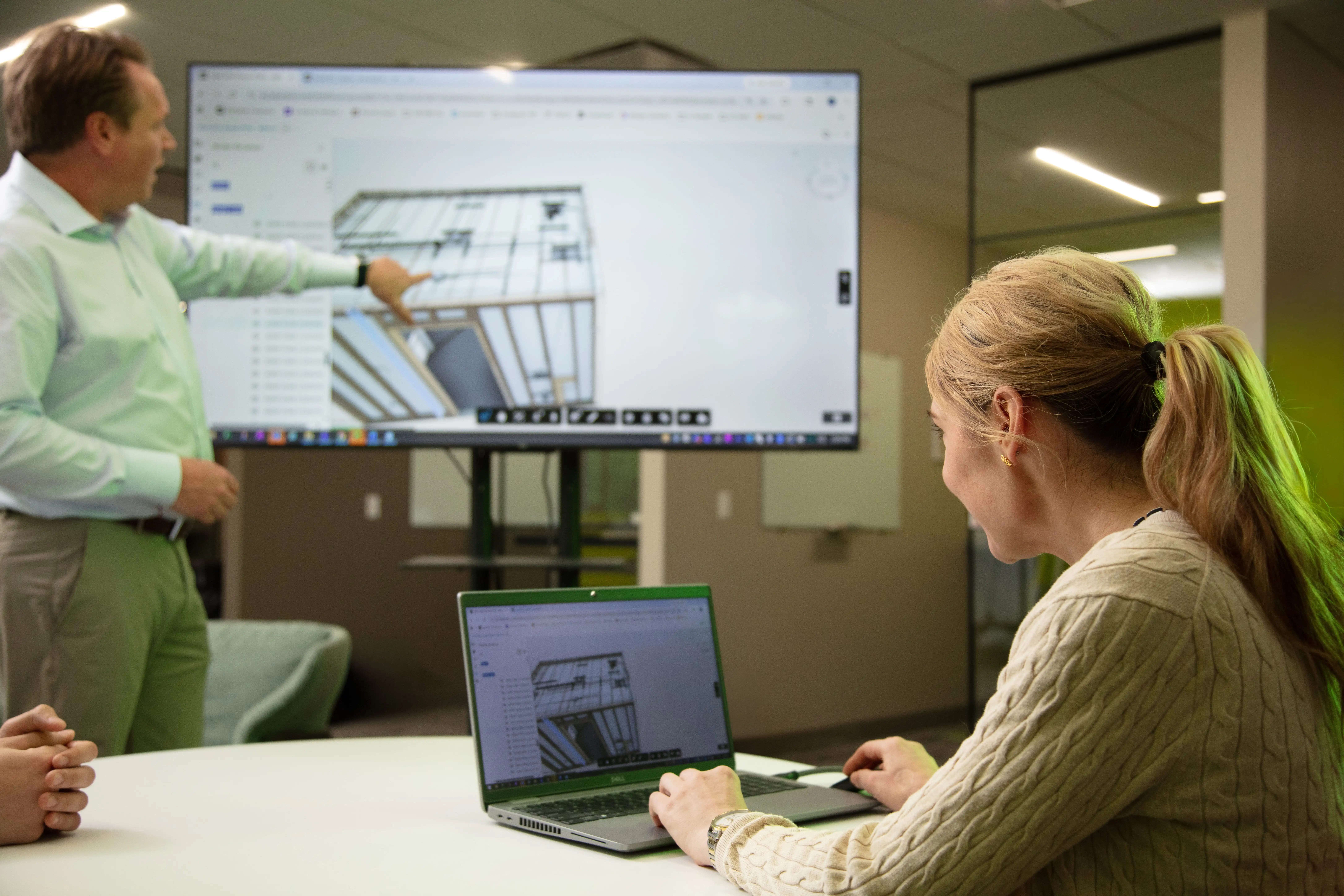 Prefabrication planning session with architectural drawings
