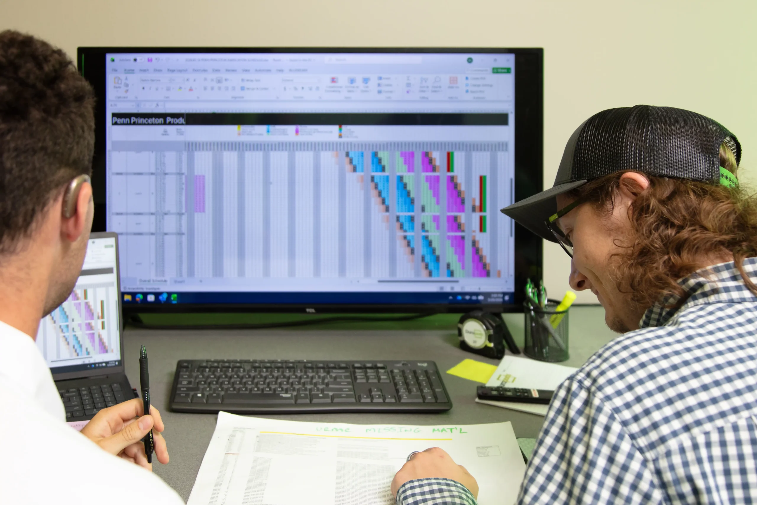 Prefabrication planning session with architectural drawings